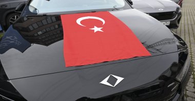 A T10F model of Türkiye’s Togg electric car with a Turkish flag is seen during a gathering in Stuttgart, Germany, Oct. 31, 2025. (AA Photo)