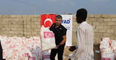 Disaster and Emergency Management Authority (AFAD) team members distribute food packages to displaced families in camps near Port Sudan, Sudan, Nov. 8, 2025. (AA Photo)