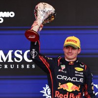 Red Bull&#039;s Max Verstappen celebrates on the podium with a trophy after finishing third in the Sao Paulo Grand Prix at the Autodromo Jose Carlos Pace, Sao Paulo, Brazil, Nov. 9, 2025. (Reuters Photo)