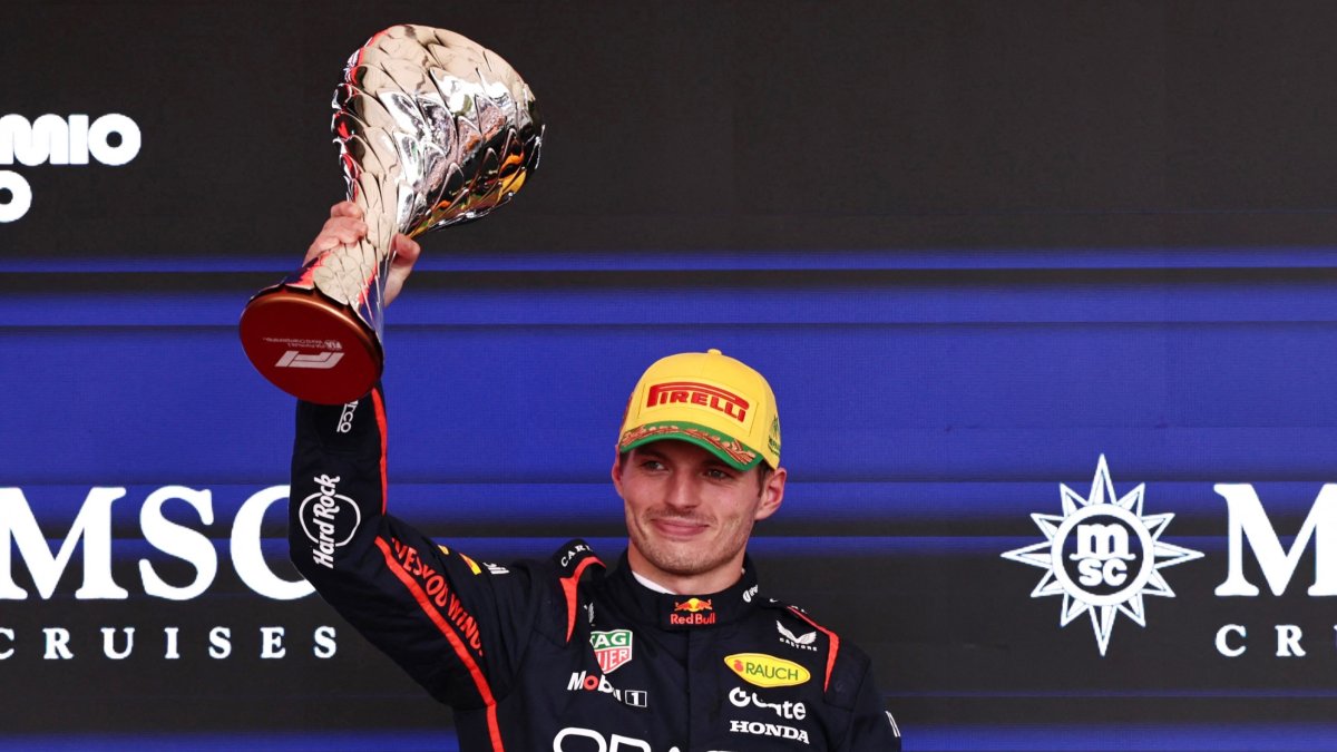 Red Bull's Max Verstappen celebrates on the podium with a trophy after finishing third in the Sao Paulo Grand Prix at the Autodromo Jose Carlos Pace, Sao Paulo, Brazil, Nov. 9, 2025. (Reuters Photo)