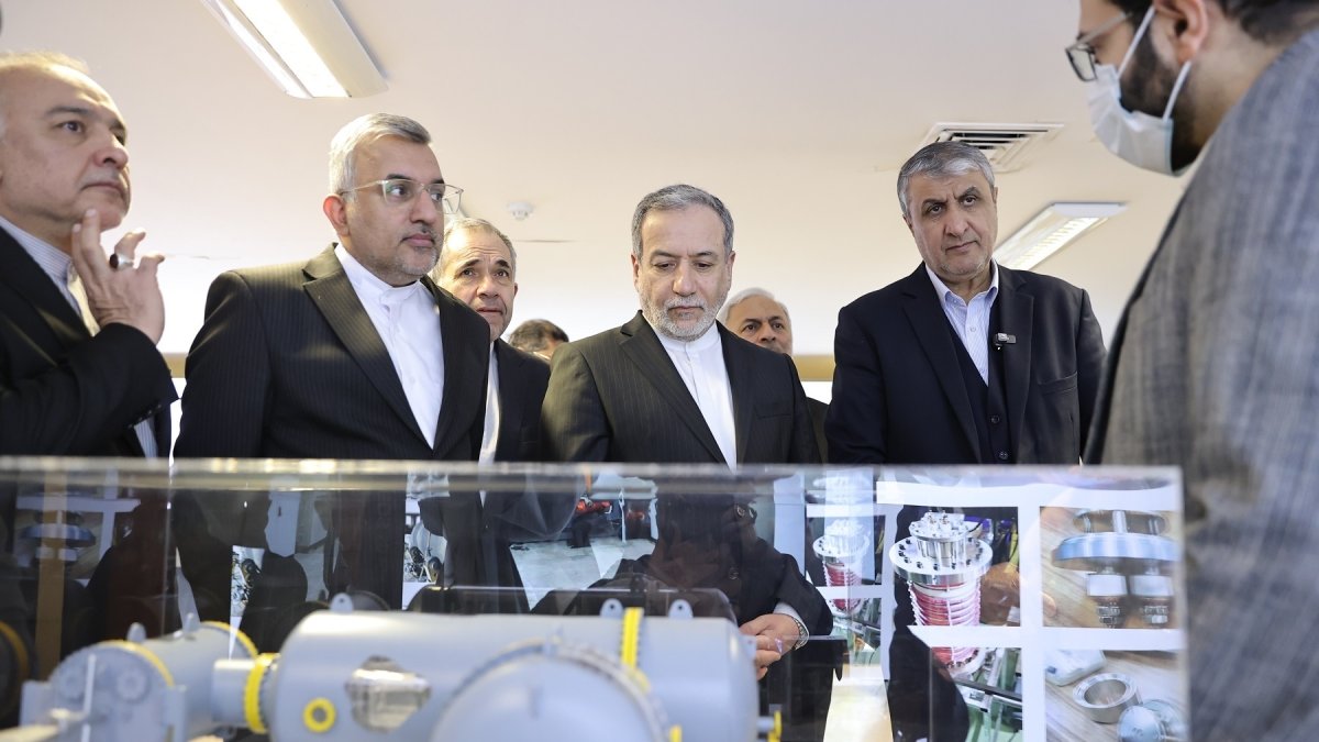 In this photo, released on Monday, Nov. 10, 2025 by the Atomic Energy Organization of Iran, Foreign Minister Abbas Araghchi (C) listens to explanations as he visits an exhibition of the country's nuclear achievements during his tour to the Atomic Energy Organization, while he is accompanied by the head of the Atomic Energy Organization of Iran, Mohammad Eslami (2nd R), Tehran, Iran. (AP Photo)
