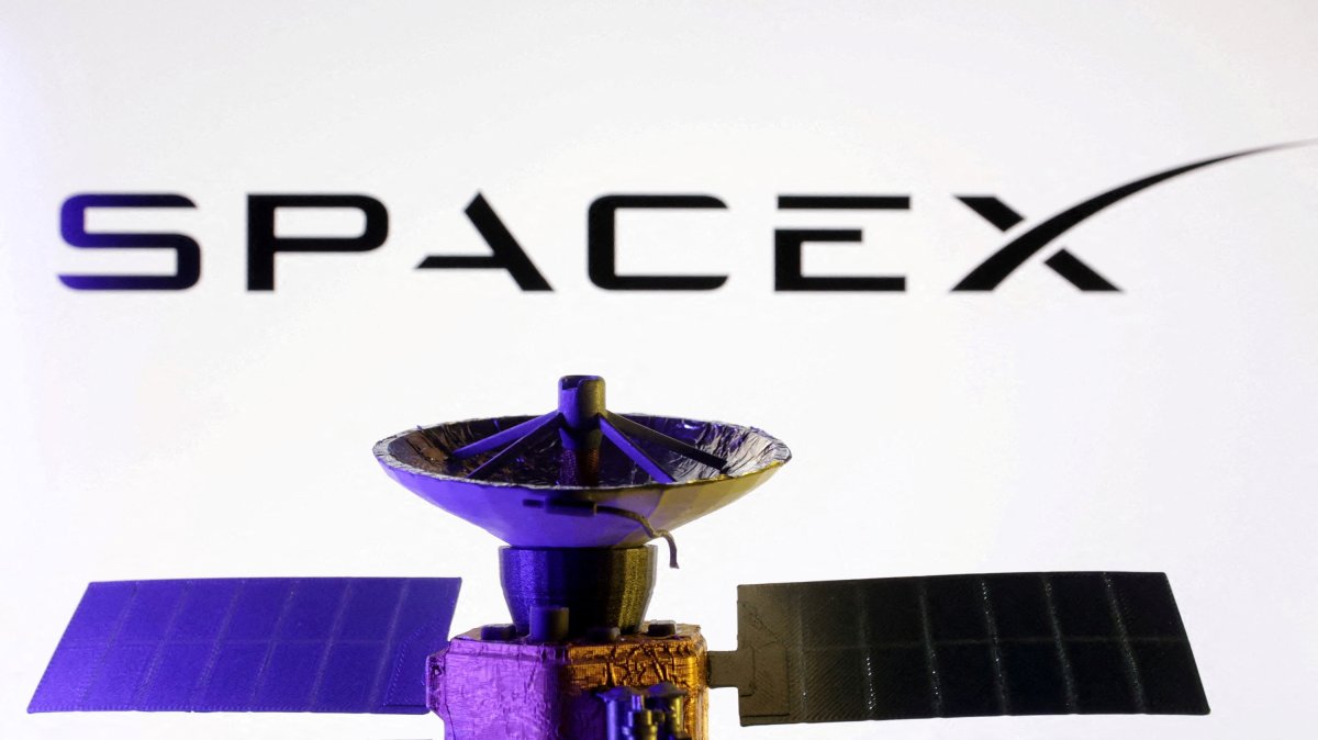 The SpaceX logo and miniature satellite model are seen in this illustration created March 10, 2025. (Reuters Photo)