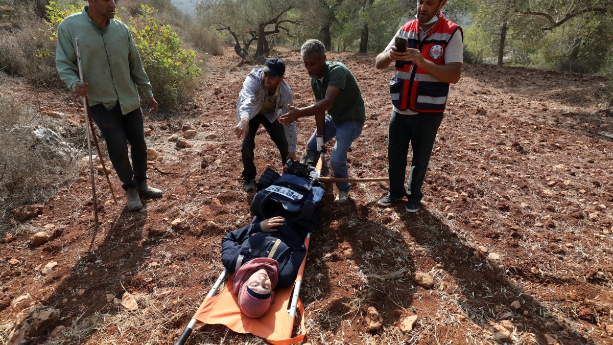 Reuters journalist Raneen Sawafta is moved by medics following an attack by Israeli settlers, near Nablus, in the Israeli-occupied West Bank, Nov. 8, 2025. (Reuters Photo)