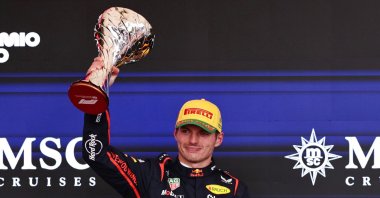 Red Bull&#039;s Max Verstappen celebrates on the podium with a trophy after finishing third in the Sao Paulo Grand Prix at the Autodromo Jose Carlos Pace, Sao Paulo, Brazil, Nov. 9, 2025. (Reuters Photo)