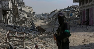 Fighters of the Al-Qassam Brigades, the military wing of the Hamas movement, stand guard as they search for the bodies of Israeli hostages alongside Red Cross workers in the east of the Gaza Strip, Nov. 2, 2025. (EPA Photo)