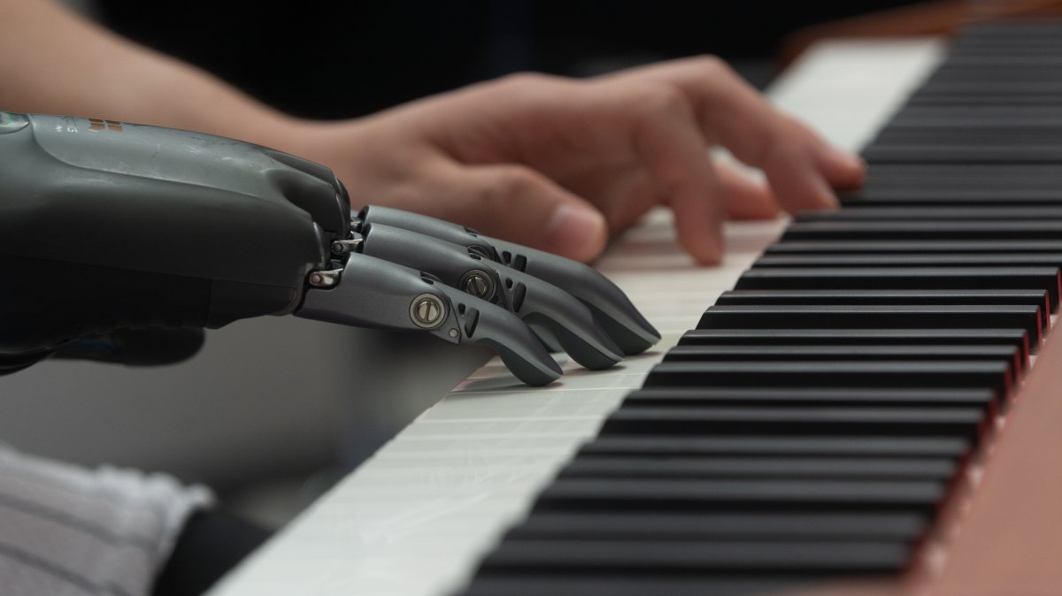 A man demonstrates a prosthetic hand playing the piano at the Shanghai New Expo Center during the World Artificial Intelligence Conference 2025, Shanghai, China, July 27, 2025. (Getty Images Photo)