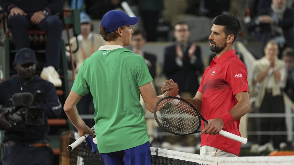 Winner Italy's Jannik Sinner (L) and Serbia's Novak Djokovic shake hands after their semifinal match of the French Tennis Open at the Roland-Garros stadium, Paris, France, June 6, 2025. (AP Photo)