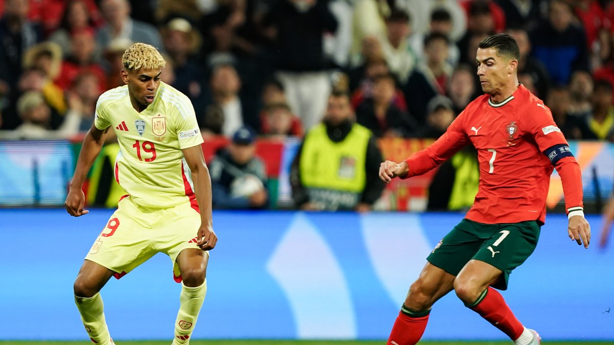 Spain's Lamine Yamal (L) and Portugal's Cristiano Ronaldo go for the ball during the UEFA Nations League 2025 final match at Munich Football Arena, Munich, Germany, June 8, 2025. (Getty Images Photo)