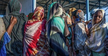 Sudanese refugees wait outside the UNHCR registration office in the Tine transit camp in Chad, Nov. 9, 2025. (AFP Photo)