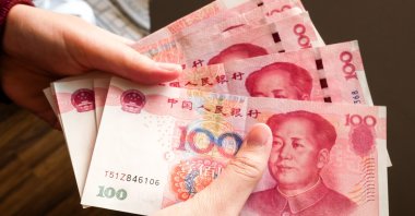In this undated photo, a person counts some banknotes of the Chinese yuan. (Shutterstock Photo)