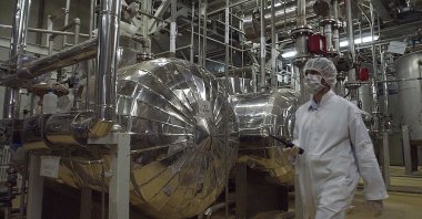 An Iranian security official in protective clothing walks through part of the Uranium Conversion Facility just outside the city of Isfahan, Iran, March 30, 2005. (AP Photo)