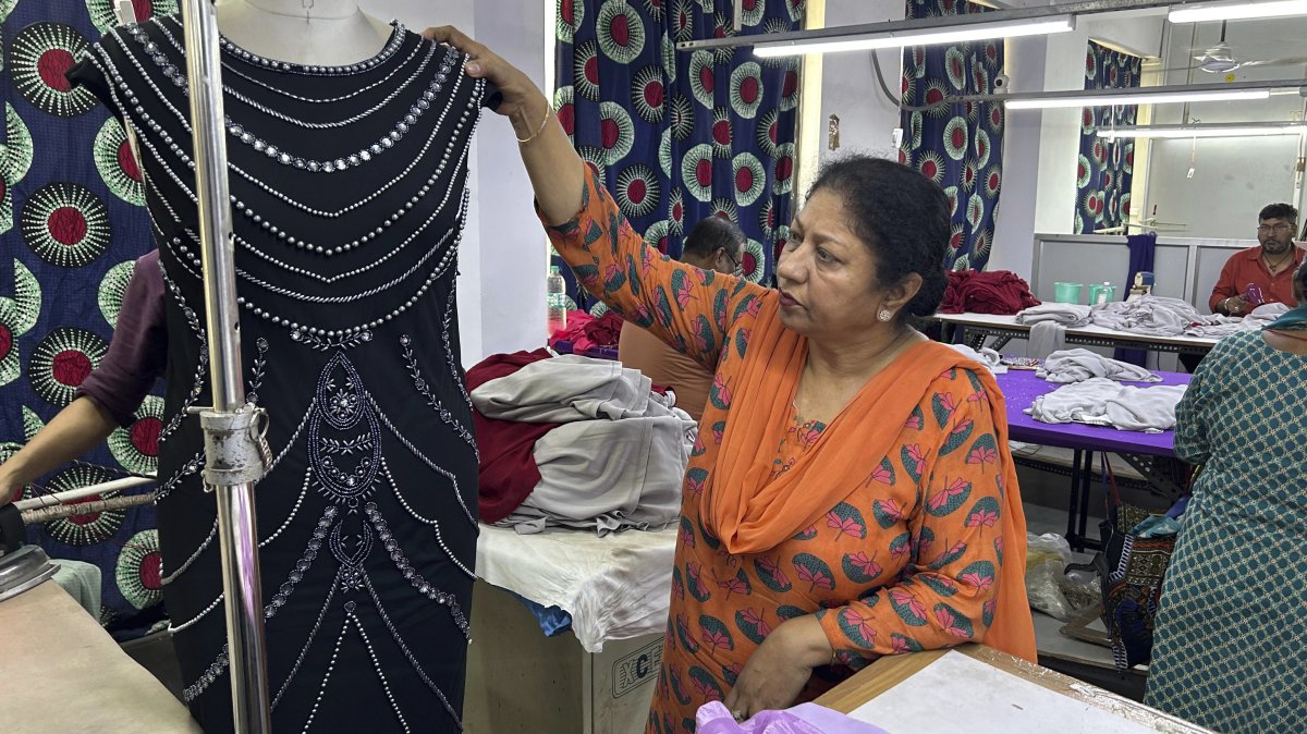 Seema Malik, director of a garment manufacturing facility, inspects that will be exported, in New Delhi, India, Aug. 7, 2025. (AP Photo)