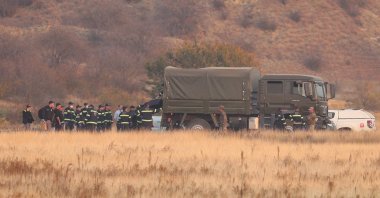 Members of emergency services work at the site of the Turkish C-130 military cargo plane crash near the Azerbaijani border, in Sighnaghi municipality, Georgia, Nov. 12, 2025. (Reuters Photo)