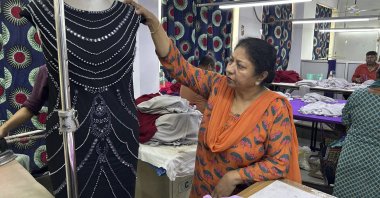 Seema Malik, director of a garment manufacturing facility, inspects that will be exported, in New Delhi, India, Aug. 7, 2025. (AP Photo)