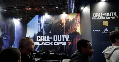 Visitors walk past a billboard promoting the soon-to-be-released Call of Duty: Black Ops 7 video game during the Paris Games Week fair, Paris, France, Oct. 30, 2025. (AFP Photo)