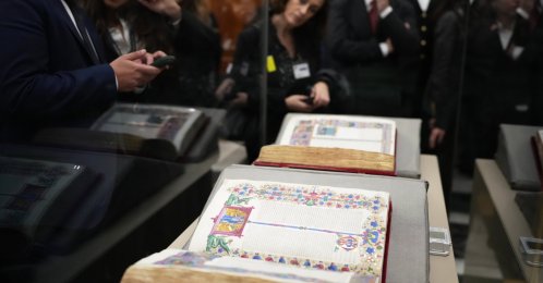 Reporters look at the 15th-century Borso D&#039;Este Bible, comprising two illuminated manuscripts, after its unveiling at the Italian Senate as part of the Vatican&#039;s Holy Year celebrations, Rome, Italy, Nov. 13, 2025. (AP Photo)