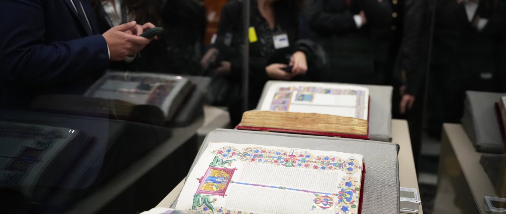 Reporters look at the 15th-century Borso D&#039;Este Bible, comprising two illuminated manuscripts, after its unveiling at the Italian Senate as part of the Vatican&#039;s Holy Year celebrations, Rome, Italy, Nov. 13, 2025. (AP Photo)