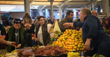 People shop at a local marketplace in Balıkesir province, western Türkiye, Nov. 1, 2025. (AA Photo)