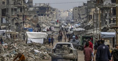 Palestinians walk among the ruins of destroyed buildings at Al-Jala street in Gaza City, Gaza Strip, Nov. 14, 2025. (EPA Photo)
