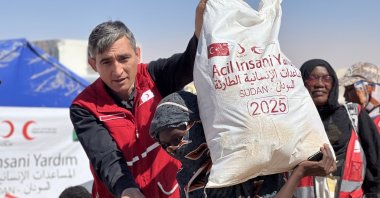 Turkish Red Crescent officials deliver humanitarian aid to displaced Sudanese people at al-Afadh camp in northern city of al-Dabbah, Sudan, Nov. 14, 2025. (AA Photo)