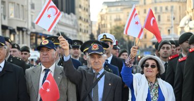 Veterans hold flags of Türkiye and the Turkish Republic of Northern Cyprus (TRNC) during a parade for TRNC&#039;s founding in Istanbul, Türkiye, Nov. 15, 2025. (AA Photo)