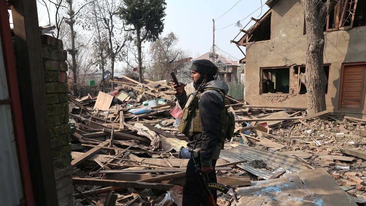 An Indian soldier takes a photograph of the demolished house of Umar Nabi, the primary suspect in the Delhi car blast, in his hometown of Koil, Pulwama district, south of Srinagar, Indian-administered Kashmir, Nov. 14, 2025. (EPA Photo)