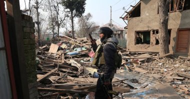 An Indian soldier takes a photograph of the demolished house of Umar Nabi, the primary suspect in the Delhi car blast, in his hometown of Koil, Pulwama district, south of Srinagar, Indian-administered Kashmir, Nov. 14, 2025. (EPA Photo)