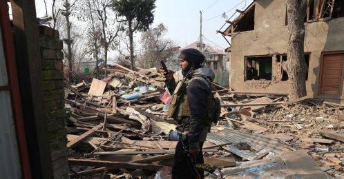 An Indian soldier takes a photograph of the demolished house of Umar Nabi, the primary suspect in the Delhi car blast, in his hometown of Koil, Pulwama district, south of Srinagar, Indian-administered Kashmir, Nov. 14, 2025. (EPA Photo)