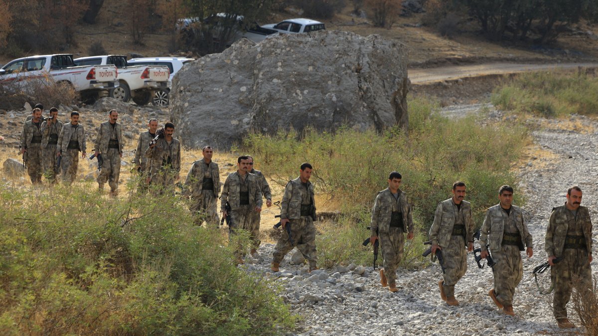 PKK terrorists walk for a disarmament ceremony in the Qandil mountains, Iraq, Oct. 26, 2025. (Reuters Photo)