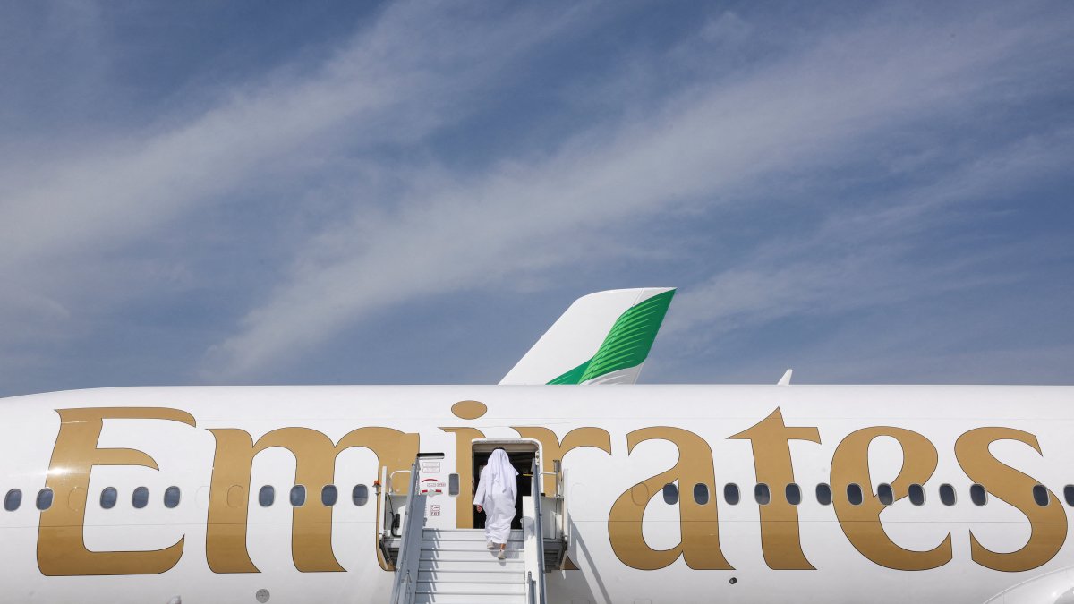 A man boards an Emirates plane displayed at the Dubai Airshow, in Dubai, United Arab Emirates, Nov. 17, 2025. (Reuters Photo)