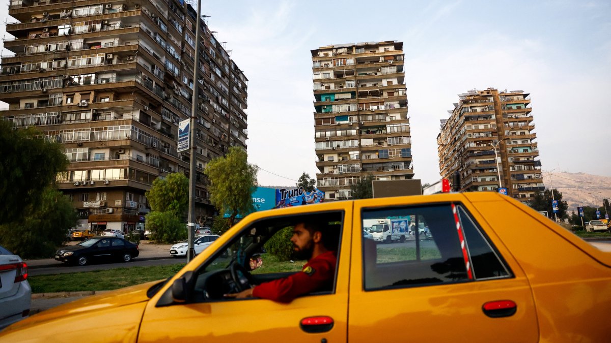 A man drives a taxi in a public square in Mezzeh, Damascus, Syria, Nov. 12, 2025. (Reuters Photo)