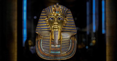 The golden funerary mask of ancient Egyptian King Tutankhamun (1341-1323 B.C.) is displayed inside the Tutankhamun Gallery at the Egyptian Grand Museum near the Giza pyramids, Cairo, Egypt, Nov. 4, 2025. (AFP Photo)