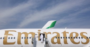 A man boards an Emirates plane displayed at the Dubai Airshow, in Dubai, United Arab Emirates, Nov. 17, 2025. (Reuters Photo)