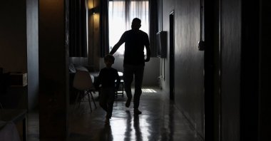A Palestinian man, one of 130 granted entry to South Africa after initially being denied for not meeting immigration requirements, walks with his child at an undisclosed location in Johannesburg, South Africa, Nov. 14, 2025. (Reuters Photo)