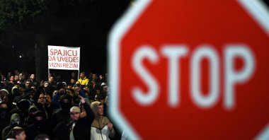 A demonstrator holds a placard reading &quot;Introduce a Visa Regime&quot; during a protest in the capital, Podgorica, Montenegro, Oct. 28, 2025. (AFP Photo)