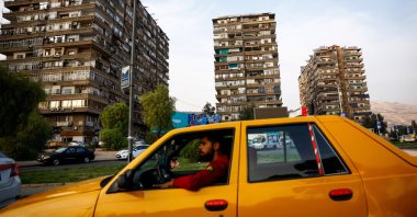 A man drives a taxi in a public square in Mezzeh, Damascus, Syria, Nov. 12, 2025. (Reuters Photo)