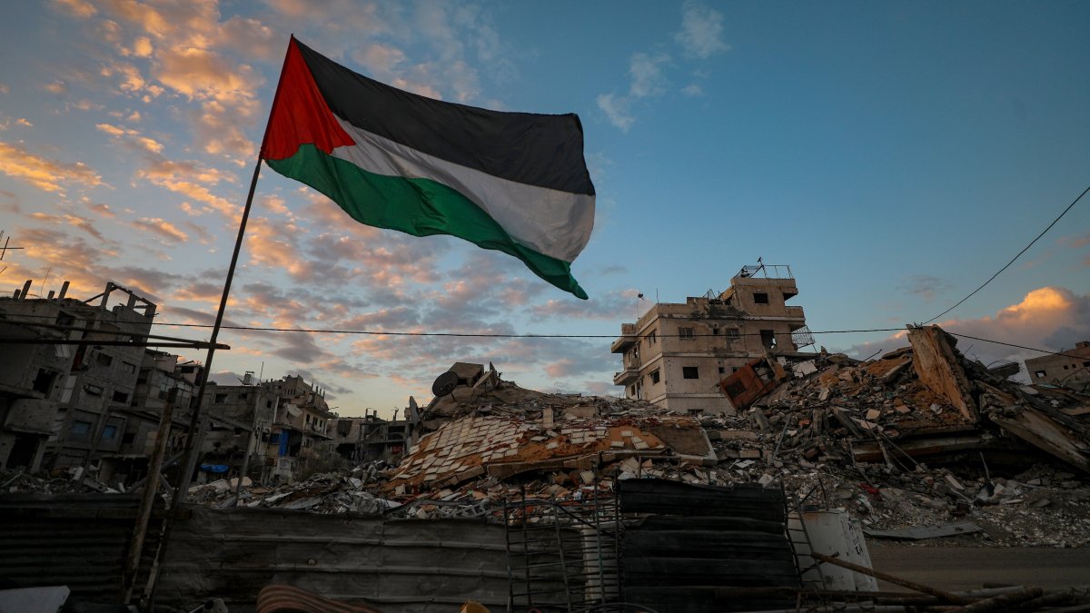 A Palestinian flag waves near the rubble of destroyed buildings on a rainy day in the east of Gaza City, Gaza Strip, Palestine, Nov. 16, 2025. (EPA Photo)