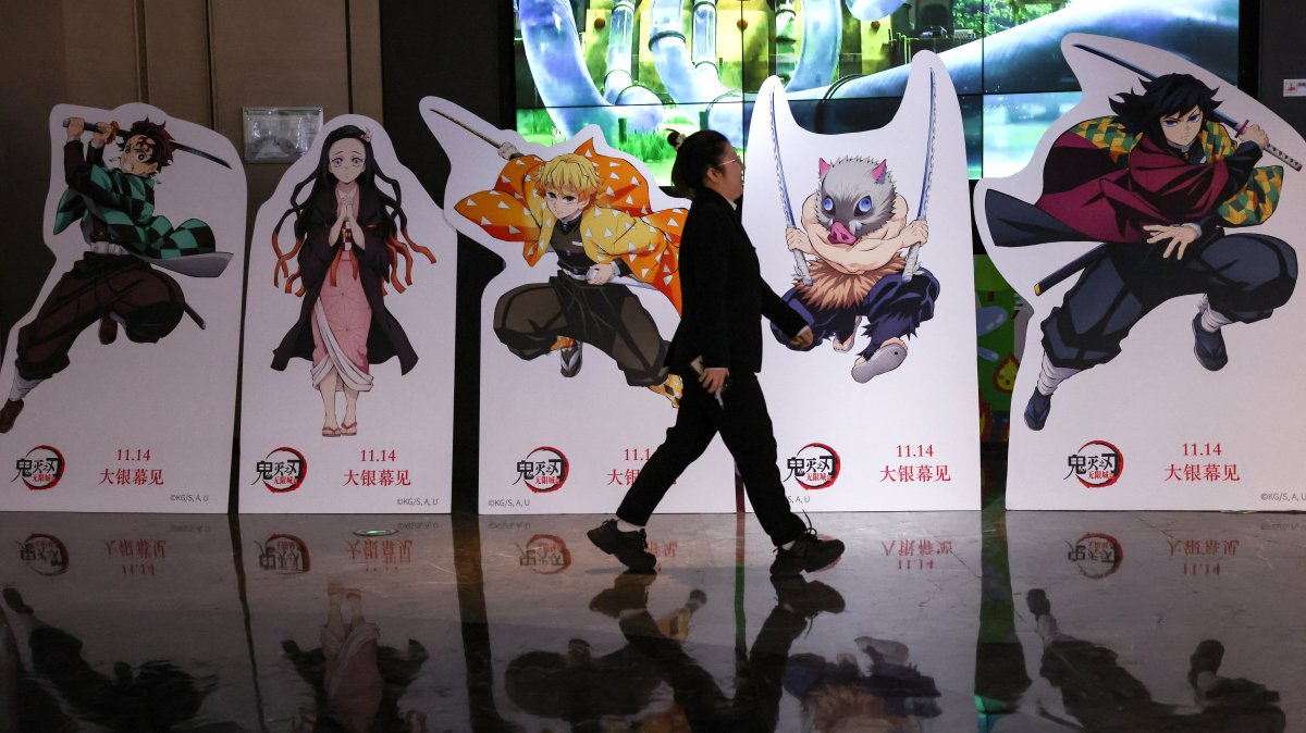 A woman walks past a promotional installation for the Japanese animated film "Demon Slayer: Kimetsu no Yaiba Infinity Castle," outside a cinema, Beijing, China, Nov. 18, 2025. (Reuters Photo)