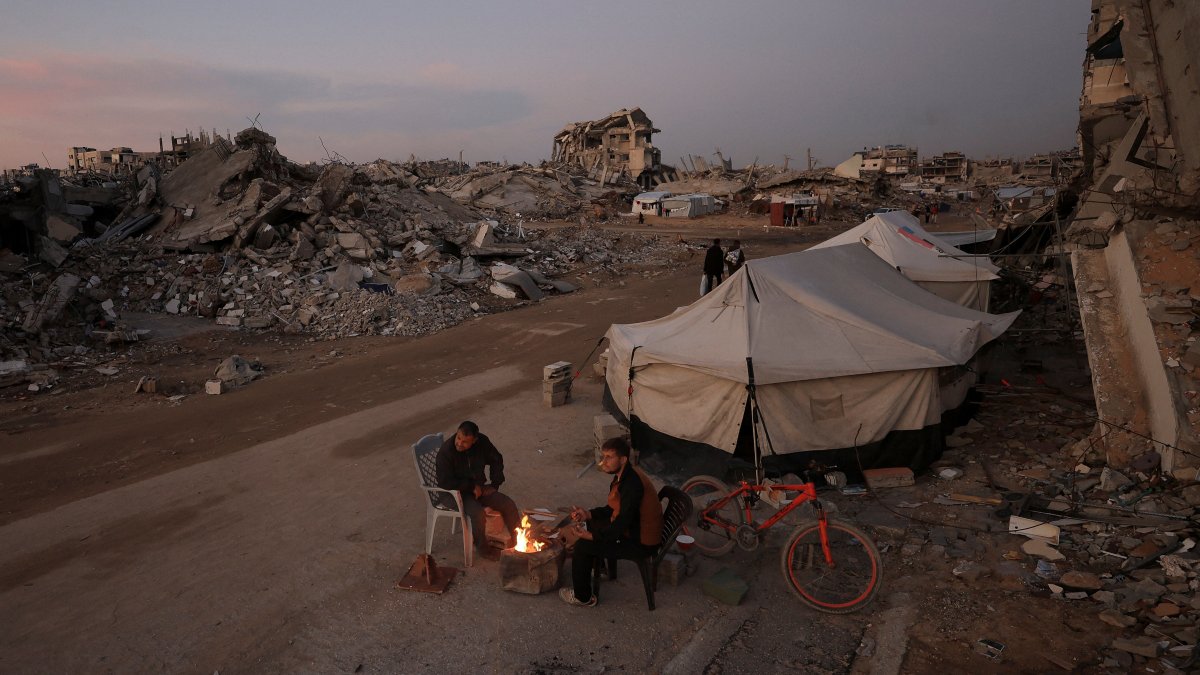 Palestinians sit next to a fire, amid a cease-fire between Israel and Hamas, in Gaza City, Palestine, Nov. 17, 2025. (Reuters Photo)