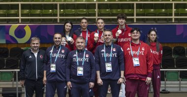 Turkish athletes and coaches pose for a group photo after winning one silver and two bronze medals in taekwondo on Day 13 of the 6th Islamic Solidarity Games, Riyadh, Saudi Arabia, Nov. 16, 2025. (AA Photo)