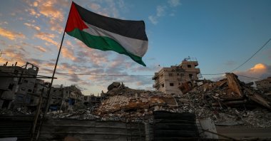 A Palestinian flag waves near the rubble of destroyed buildings on a rainy day in the east of Gaza City, Gaza Strip, Palestine, Nov. 16, 2025. (EPA Photo)