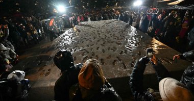 Demonstrators stand around a memorial commemorating the events of the Velvet Revolution as it is unveiled in Bratislava, Slovakia, Nov. 17, 2025. (AFP Photo)