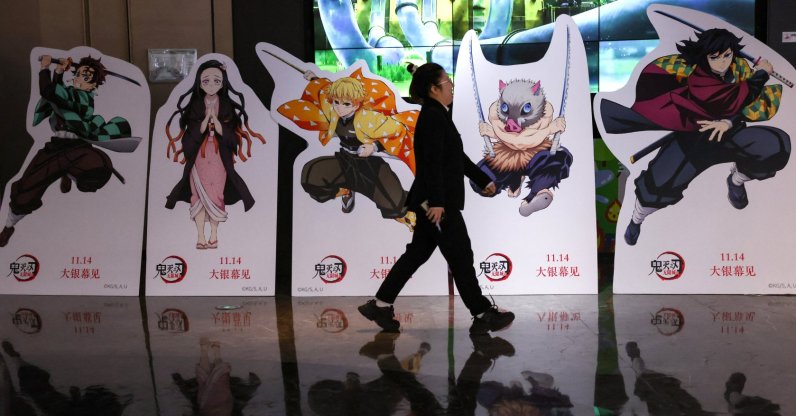 A woman walks past a promotional installation for the Japanese animated film &quot;Demon Slayer: Kimetsu no Yaiba Infinity Castle,&quot; outside a cinema, Beijing, China, Nov. 18, 2025. (Reuters Photo)