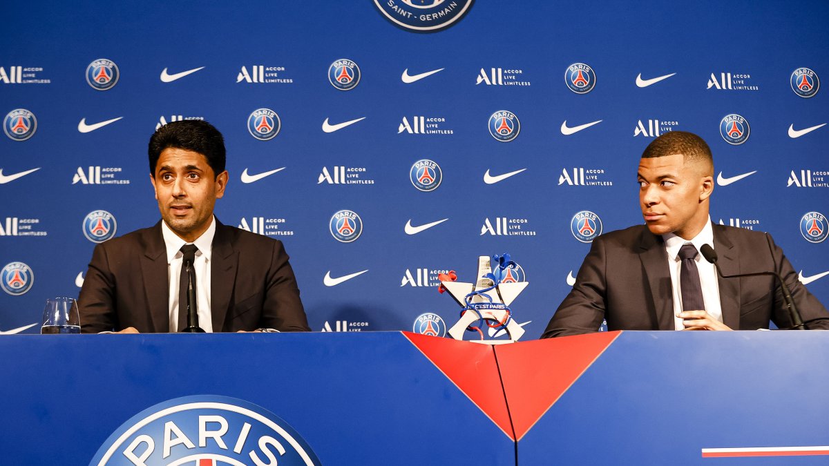 Nasser Al-Khelaifi (L) and Kylian Mbappe (R) talk during the Press Conference of Paris Saint-Germain at Parc des Princes, Paris, France, May 23, 2022. (Getty Images Photo)