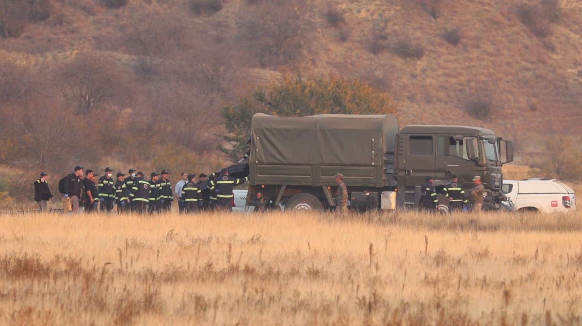 Members of emergency services work at the site of the Turkish C-130 military cargo plane crash near the Azerbaijani border, Sighnaghi municipality, Georgia, Nov. 12, 2025. (Reuters Photo)