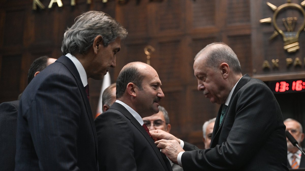President Recep Tayyip Erdoğan attaches a badge of the Justice and Development Party (AK Party) on the jacket of Mayor Necati Koç, Ankara, Türkiye, Nov. 19, 2025. (AA Photo)