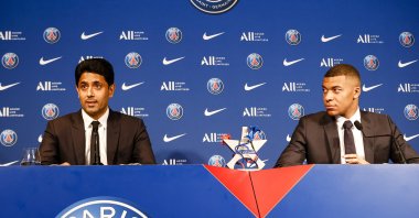 Nasser Al-Khelaifi (L) and Kylian Mbappe (R) talk during the Press Conference of Paris Saint-Germain at Parc des Princes, Paris, France, May 23, 2022. (Getty Images Photo)