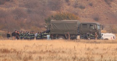 Members of emergency services work at the site of the Turkish C-130 military cargo plane crash near the Azerbaijani border, Sighnaghi municipality, Georgia, Nov. 12, 2025. (Reuters Photo)