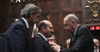 President Recep Tayyip Erdoğan attaches a badge of the Justice and Development Party (AK Party) on the jacket of Mayor Necati Koç, Ankara, Türkiye, Nov. 19, 2025. (AA Photo)