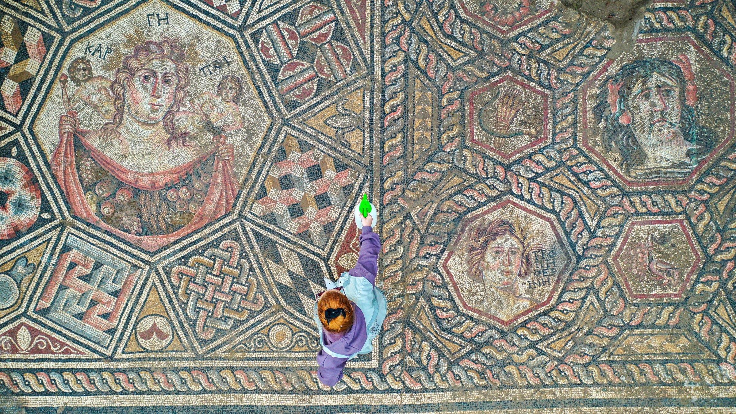 A third-century mosaic uncovered this year shows a woman with a basket of fruit (L), a depiction of a personified Lake Iznik with crab-claw hair ornaments (top right) and geometric motifs, Iznik, Bursa, Türkiye, Nov. 18, 2025. (AA Photo)